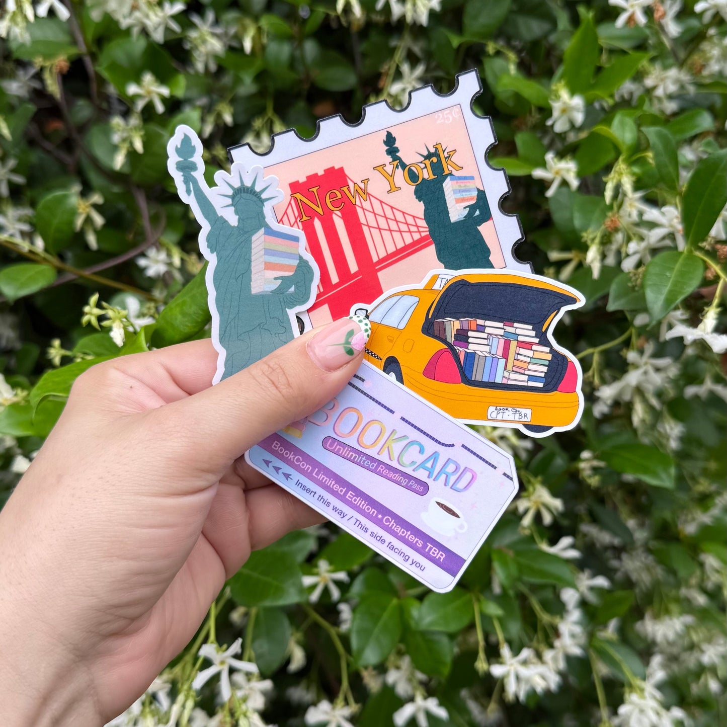 Hand holding a colorful travel-themed discount card with illustrations of landmarks against a green leafy background.