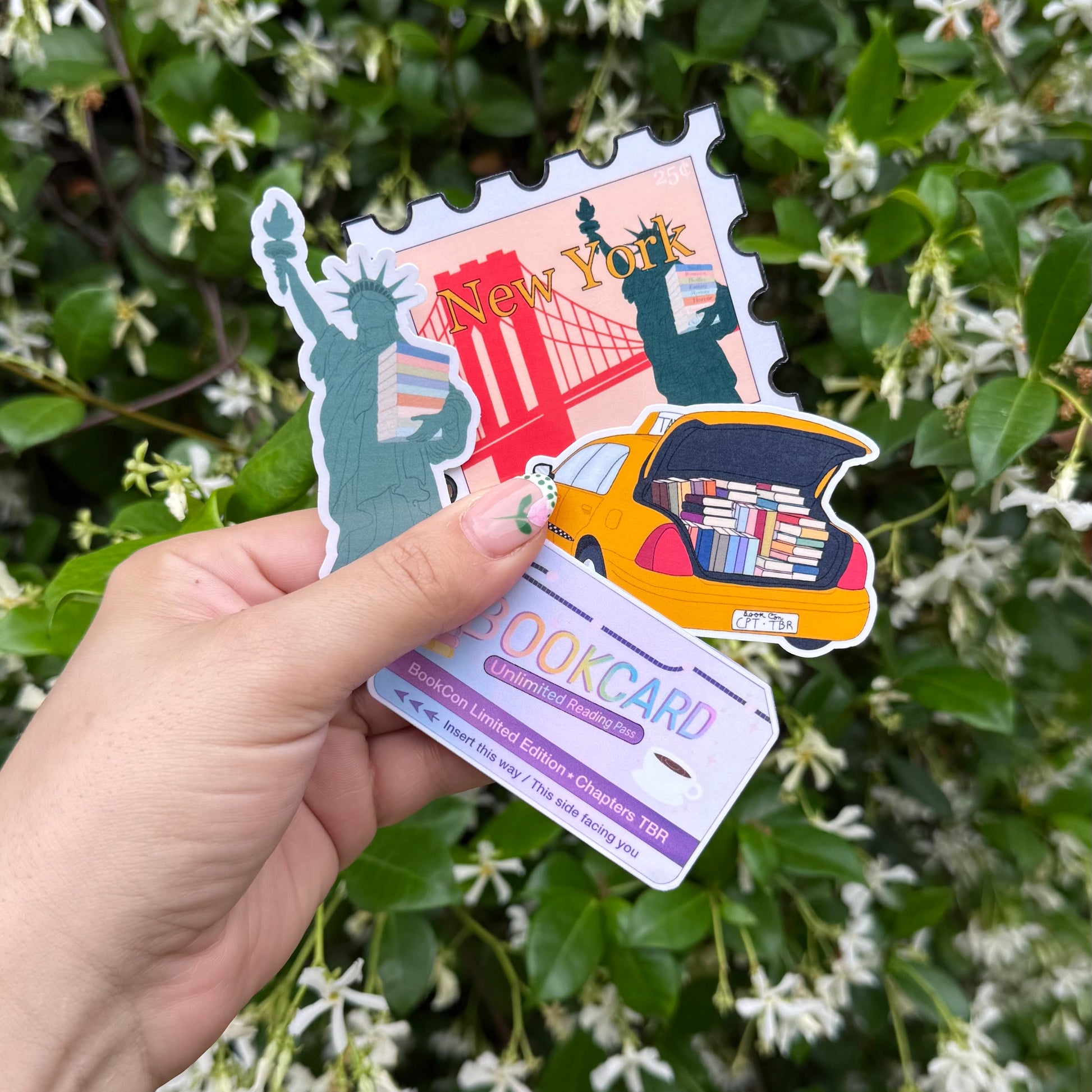 Hand holding a colorful travel-themed discount card with illustrations of landmarks against a green leafy background.