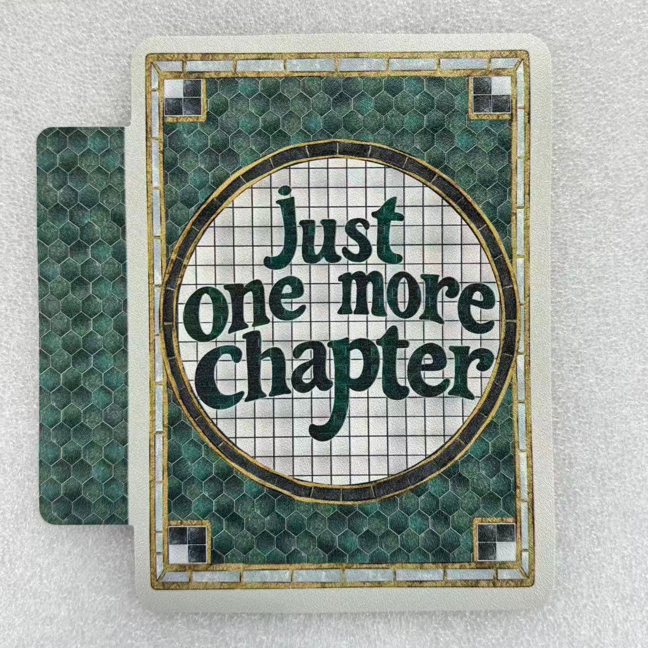 Book with 'Just one more chapter' text on a textured surface